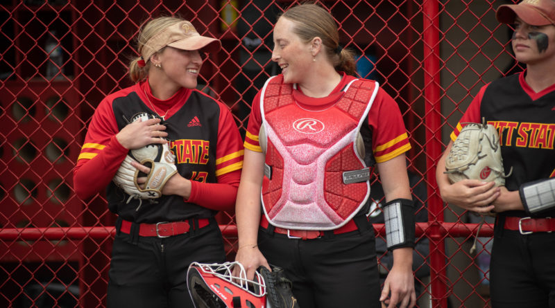 Senior third baseman Kori Stonestreet talks with junior catcher Gracie Sullivan in the pre-game huddle before their game against the Washburn Ichabods on Saturday, April 15 at the Pitt State Softball Complex.